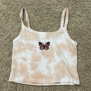 I’m selling a light orange and white tank top w a butterfly in the middle